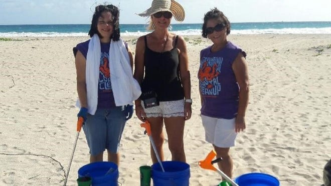 Volunteers Olga Sierra, Teresa Stephens and Olga Robles help pick up trash Dec. 17 in Palm Beach. Courtesy of Friends of Palm Beach