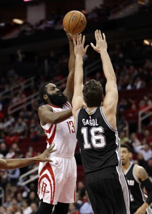 Houston Rockets' James Harden (13) shoots as San Antonio Spurs' Pau Gasol (16) defends during the first half of an NBA basketball game Tuesday, Dec. 20, 2016, in Houston. (AP Photo/David J. Phillip)