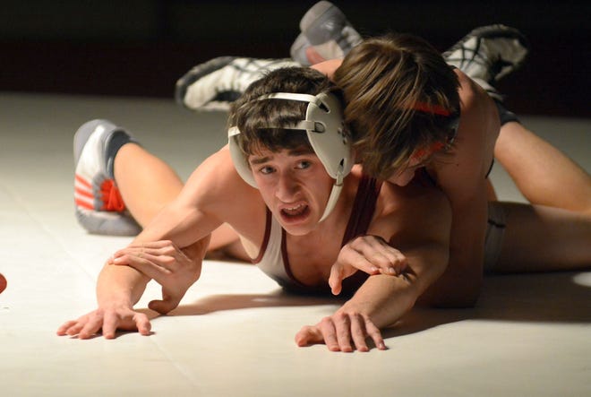 Noble's Jaden Balcewicz doesn't look too pleased at where he's at, but he did recover to beat Wells' Ryan Norton by major decision, 16-7, at 113 pounds during Wednesday's wrestling match in North Berwick, Maine. Photo by Mike Whaley/Fosters.com