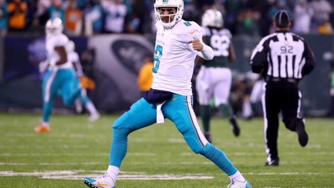 EAST RUTHERFORD, NJ - DECEMBER 17: Matt Moore #8 of the Miami Dolphins celebrates after throwing a 52 yard touchdown pass to Kenny Stills #10 against the New York Jets during the second quarter of the game at MetLife Stadium on December 17, 2016 in East Rutherford, New Jersey. (Photo by Al Bello/Getty Images)