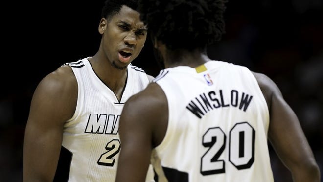 MIAMI, FL - DECEMBER 18: Hassan Whiteside #21 of the Miami Heat speaks with Justise Winslow #20 during the game against the Boston Celtics at the American Airlines Arena on December 18, 2016 in Miami, Florida. NOTE TO USER: User expressly acknowledges and agrees that, by downloading and or using this photograph, User is consenting to the terms and conditions of the Getty Images License Agreement.ÃŠ(Photo by Rob Foldy/Getty Images)