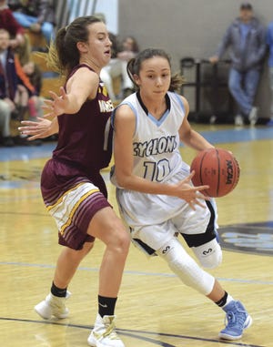 Pueblo West High School freshman Hannah Simental drives past Windsor High School's Sam Greene during the Cyclones' 64-49 win over the Wizards Wednesday, Dec. 21, 2016 at Pueblo West High School.
