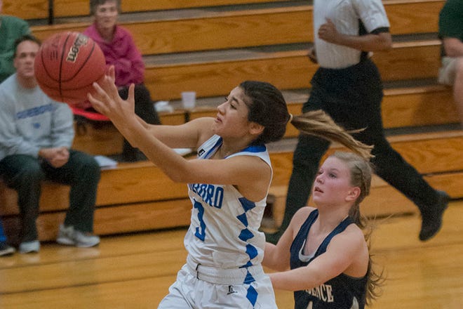 Asheboro's Rachel Luna tries to run down a high pass on a breakaway as PG's Anna Thomas pursues. Luna scored 22 points to lead AHS to victory Thursday.