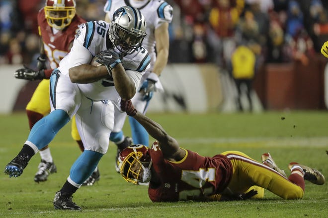 Carolina Panthers fullback Mike Tolbert (35) drags Washington Redskins cornerback Josh Norman (24) across the field during the second half of an NFL football game in Landover, Md., Monday, Dec. 19, 2016. The Panthers defeated the Redskins 26-15. (AP Photo/Patrick Semansky)