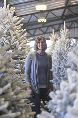Sarah Delp, a third generation Christmas tree farmer, stands in a room of flocked white Christmas trees on sale at the Delp Christmas Tree Farm on December 3, 2015.