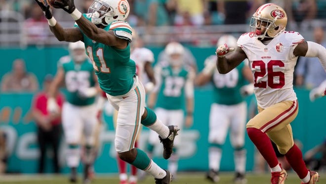 Miami Dolphins wide receiver DeVante Parker (11) pulls in a long pass for a first down in the first quarter as San Francisco 49ers cornerback Tramaine Brock (26) defends at Hard Rock Stadium in Miami Gardens, Florida on November 27, 2016. (Allen Eyestone / The Palm Beach Post)