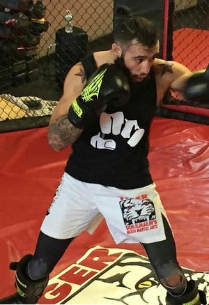 Shane Burgos is now 8-0 as a mixed martial arts fighter. The 2009 Monroe-Woodbury graduate's latest victory came against Tiago Trator in a UFC Fight Night 102 featherweight battle Dec. 9 in Albany. Provided photo
