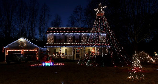 The Brown family really get into the holiday spirit while decorating their house on Old Forge Rd. in Gastonia. JOHN CLARK/THE GAZETTE