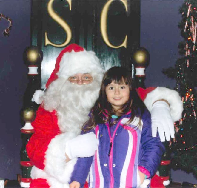 Addison Hendershot, 5, of Hillsdale poses for a picture with Santa Claus on Dec. 9 during an Old-Fashioned Christmas in Reading. COURTESY PHOTO