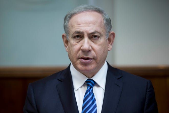 FILE - In this Dec. 11, 2016, file photo, Israeli Prime Minister Benjamin Netanyahu attends the weekly cabinet meeting at his office in Jerusalem. Netanyahu lashed out at President Barack Obama on Saturday, Dec. 24, accusing him of a “shameful ambush” at the United Nations over West Bank settlements and saying he is looking forward to working with his “friend” President-elect Donald Trump. Netanyahu’s comments came a day after the United States broke with past practice and allowed the U.N. Security Council to condemn Israeli settlements in the West Bank and east Jerusalem as a “flagrant violation” of international law. (Abir Sultan, Pool via AP)