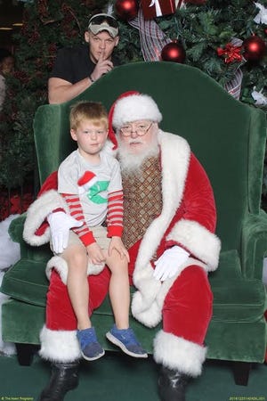 U.S. Air Force Staff Sgt. Chris Stewart surprised his 6-year-old son Colton on Wednesday while they boy was visiting with Santa Claus at the Paddock Mall. Photo courtesy Paddock Mall.