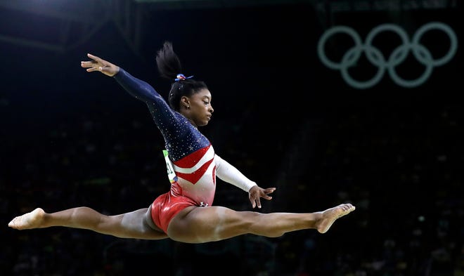 FILE - In this Aug. 9, 2016 file photo, United States’ Simone Biles performs on the balance beam during the artistic gymnastics women’s team final at the Summer Olympics in Rio de Janeiro, Brazil. Briles was selected as the AP Female Athlete of the Year, on Monday, Dec. 26, 2016. (AP Photo/Rebecca Blackwell, File)
