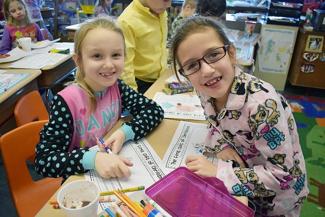 From left, Poland student Rylee Tabor, 7, and Herkimer student Katerinna Scalise, 7, are pen pals who write about subjects such as “Frozen” and how they were looking forward to meeting each other, which they did on Dec. 16 at Poland Central School. SUBMITTED PHOTO