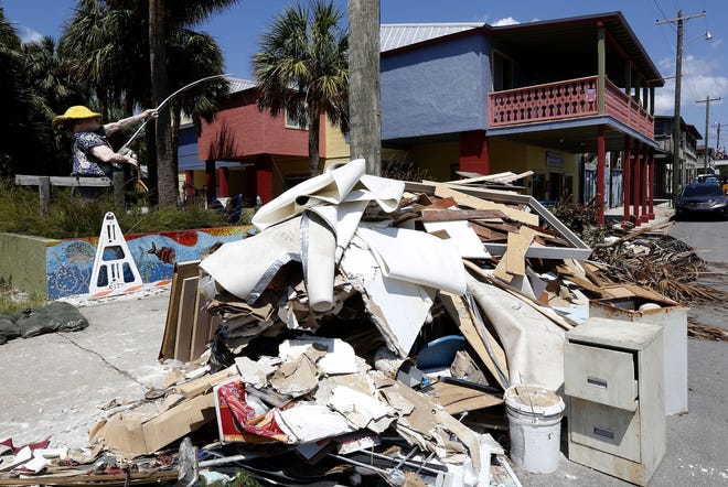 This file photo from Sept. 7 shows trash and debris piled up along 2nd Street in Cedar Key in the aftermath of Hurricane Hermine, which left many homes and businesses flooded by storm surge. The storm was just one of the news events for the state in 2016. Matt Stamey/Gainesville Sun