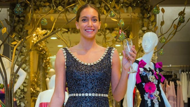 Dolce & Gabbana gown and Black-lace Pouchette chain clutch. Joseph Forzano / Daily News