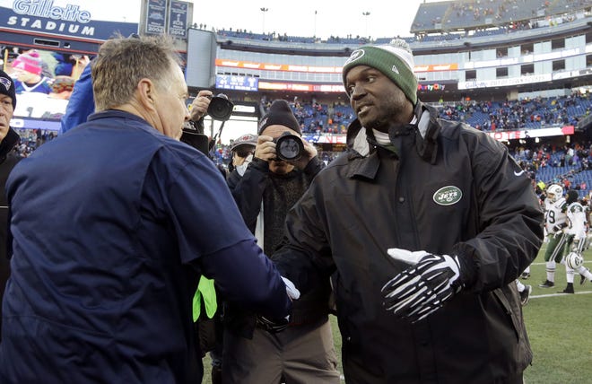 Jets head coach Todd Bowles, right, was hospitalized Friday and missed the team flight for Saturday's loss to New England. He flew the day of the game and was on the sideline for the team's sixth loss in seven games. The Associated Press