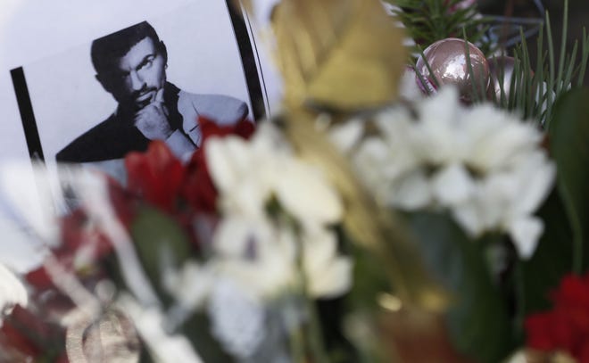 Tributes left outside the home of British musician George Michael in London, Monday, Dec. 26, 2016. George Michael, who rocketed to stardom with WHAM! and went on to enjoy a long and celebrated solo career lined with controversies, has died, his publicist said Sunday. He was 53. (AP Photo/Kirsty Wigglesworth)