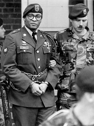 FILE - In this April 6, 1988, file photo, Ronald Gray leaves a courtroom escorted by military police at Fort Bragg, N.C. A Kansas federal judge has lifted a stay of execution for Gray, a former soldier who was sentenced to death for killing two women and a series of rapes, moving him closer to becoming the military’s first death sentence carried out in more than a half century. No known execution date has been set for Gray as of Tuesday, Dec. 27, 2016. (Marcus Castro/The Fayetteville Observer via AP, File)