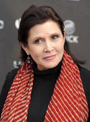 FILE - In this Thursday, April 7, 2011 file photo, Carrie Fisher arrives at the 2011 NewNowNext Awards in Los Angeles. On Tuesday, Dec. 27, 2016, a publicist said Fisher has died at the age of 60. (AP Photo/Chris Pizzello, File)