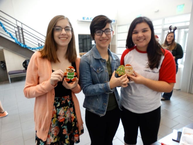 L to R: Kelsey Meshell, a senior from Bossier City, Olivia LaCour, a junior from St. Amant, and Shona McCullough, a senior from Baton Rouge, displaying the gingerbread cookies they decorated.