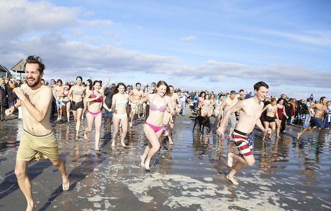 Brave souls take part in the Polar Bear Plunge at Easton’s Beach in Newport on the first day of 2016.