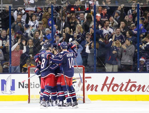 Columbus Blue Jackets players celebrate a goal against the Boston Bruins during the third period of an NHL hockey game Tuesday, Dec. 27, 2016, in Columbus, Ohio. The Blue Jackets won 4-3. (AP Photo/Jay LaPrete)
