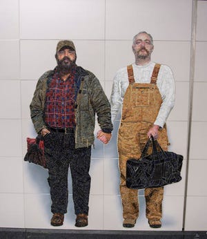 In this Nov. 29, 2016 photo provided by the New York Metropolitan Transportation Authority, a mural on the wall of the Second Avenue Subway station at 72nd Street, in New York, shows Thor Stockman, left, and his husband, Patrick Kellogg. (New York Metropolitan Transportation Authority via AP)