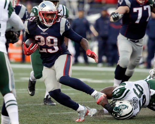 New England Patriots running back LeGarrette Blount (29) runs away from New York Jets linebacker Freddie Bishop (56) during the second half of an NFL football game, Saturday, Dec. 24, 2016, in Foxborough, Mass. (AP Photo/Charles Krupa)