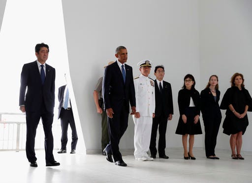President Barack Obama and Japanese Prime Minister Shinzo Abe arrive to participate in a wreath laying ceremony at the USS Arizona Memorial, part of the World War II Valor in the Pacific National Monument, in Joint Base Pearl Harbor-Hickam, Hawaii, adjacent to Honolulu, Hawaii, Tuesday, Dec. 27, 2016, as part of a ceremony to honor those killed in the Japanese attack on the naval harbor. (AP Photo/Carolyn Kaster)