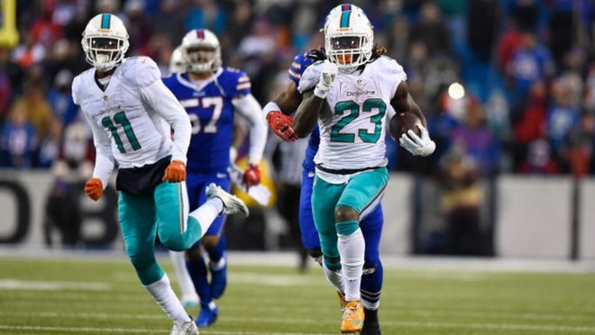 ORCHARD PARK, NY - DECEMBER 24: Jay Ajayi #23 of the Miami Dolphins runs the ball against the Buffalo Bills during overtime at New Era Stadium on December 24, 2016 in Orchard Park, New York. (Photo by Rich Barnes/Getty Images)