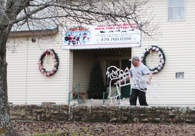 Miguel Devora begins disassembling the Christmas lights on display Monday, Dec 26, 2016, in front of the Christmas Wonderland, 7300 Wells Lake Road at Chaffee Crossing, for storage until next year. JAMIE MITCHELL/TIMES RECORD