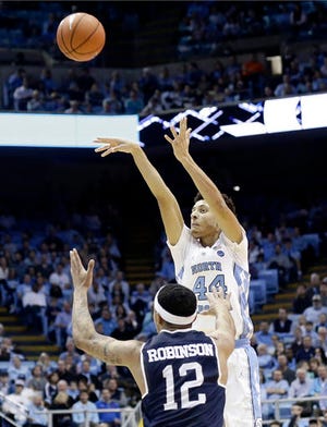 North Carolina's Justin Jackson (44) shoots over Monmouth's Justin Robinson (12) during the first half of an NCAA college basketball game in Chapel Hill, N.C., Wednesday, Dec. 28, 2016. (AP Photo/Gerry Broome)