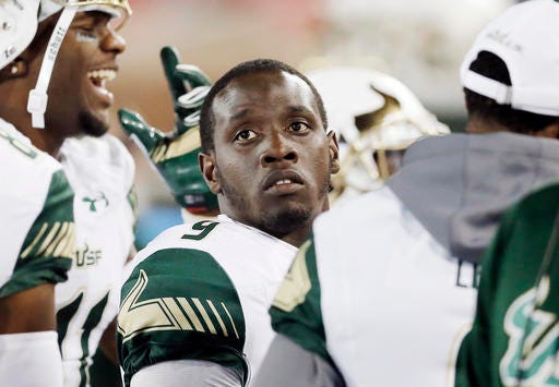 This Nov. 19, 2016 photo shows South Florida quarterback Quinton Flowers (9) looking on from the sidelines during the second half of an NCAA college football game against SMU in Dallas. South Carolina will face South Florida on Thursday in the Birmingham Bowl. (AP Photo/Brandon Wade)