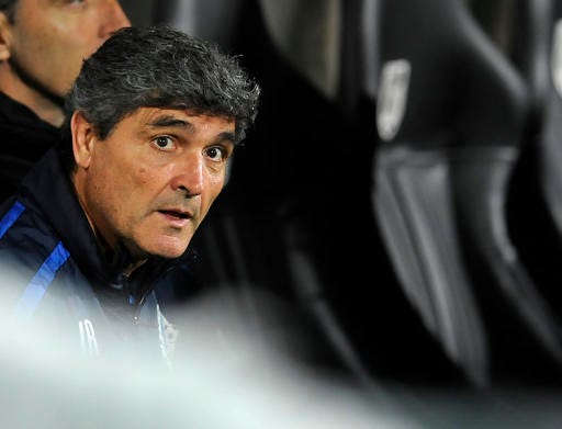 FILE - In this Thursday, Oct. 24, 2013 file photo, Juande Ramos, Dnipro's coach at that time, watches from the bench during their Europa League Group E soccer match against Pacos Ferreira at the D. Afonso Henriques Stadium, in Guimaraes, Portugal. Malaga coach Juande Ramos is leaving the Spanish club after just half a season in charge. In a statement released late on Tuesday, Dec. 27, 2016. Qatari-owned club said that Ramos had agreed to cut short his contract that was good through the 2018-19 season. (AP Photo/Paulo Duarte, File)