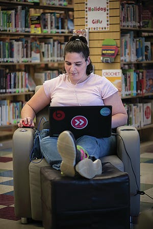Logan County’s Megan Case shows how easy it is to take advantage of internet access at the library. Todd Johnson/Oklahoma State University