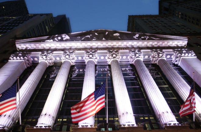 FILE - In this Wednesday, Oct. 8, 2014, file photo, American flags fly in front of the New York Stock Exchange. Global shares mostly fell in thin trading Thursday, Dec. 29, 2016, taking their cues from a slide on Wall Street. A stronger yen helped send Japanese stocks lower. (AP Photo/Mark Lennihan, File)