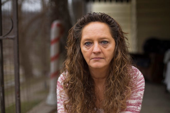 In this Monday, Dec. 19, 2016 photo, Donna Dye, who is unemployed and whose husband is disabled, sits outside her home in Minnie, Ky. She and her husband have been fighting the federal government to keep his Social Security disability checks after a local lawyer who helped them became the subject of a federal fraud investigation. (AP Photo/David Stephenson)