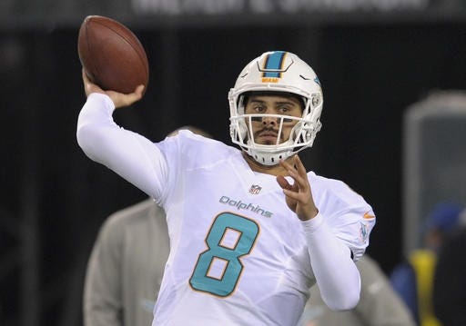 Dolphins quarterback Matt Moore leads the playoff-bound Dolphins offense in a regular-season finale on Sunday against the Patriots in Miami. AP FILE PHOTO/BILL KOSTROUN