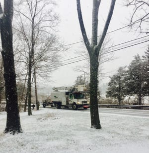 Snow covers Route 519 in Fredon, as a tree service truck passes by Thursday morning.