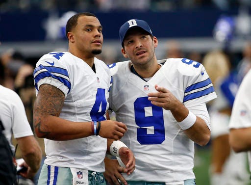 FILE - In a Sunday, Nov. 20, 2016 file photo, Dallas Cowboys' Dak Prescott (4) and Tony Romo (9) talk on the sideline in the first half of an NFL football game against the Baltimore Ravens in Arlington, Texas. The Cowboys went on a record-setting run without quarterback Romo, thanks to a pair of star rookies, Dak Prescott and Esekiel Elliott. (AP Photo/Michael Ainsworth, File)
