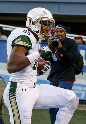 University of South Florida tight end Elkanah Dillon (85) celebrates his go-ahead touchdown Thursday during overtime of the Birmingham Bowl NCAA college football game against South Carolina, in Birmingham, Ala. (AP Photo/Butch Dill)