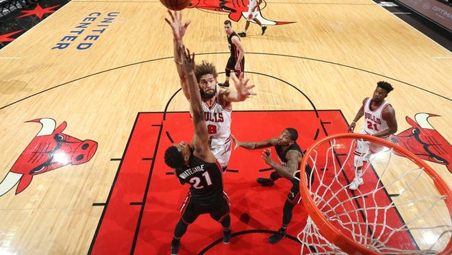 CHICAGO, IL - DECEMBER 10: Robin Lopez #8 of the Chicago Bulls shoots the ball over Hassan Whiteside #21 of the Miami Heat during a game on December 10, 2016 at the United Center in Chicago, Illinois. NOTE TO USER: User expressly acknowledges and agrees that, by downloading and/or using this photograph, user is consenting to the terms and conditions of the Getty Images License Agreement. Mandatory Copyright Notice: Copyright 2016 NBAE (Photo by Nathaniel S. Butler/NBAE via Getty Images)