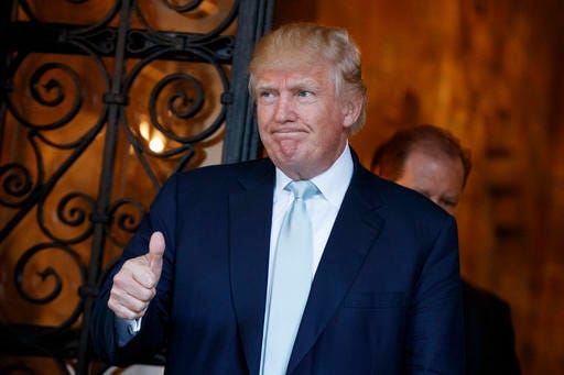President-elect Donald Trump gives a thumbs up to reporters at Mar-a-Lago, Wednesday in Palm Beach.