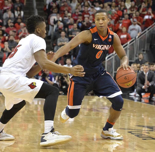 Devon Hall and Virginia pulled off the first major victory in ACC play, knocking off sixth-ranked Louisville on Wednesday night.
