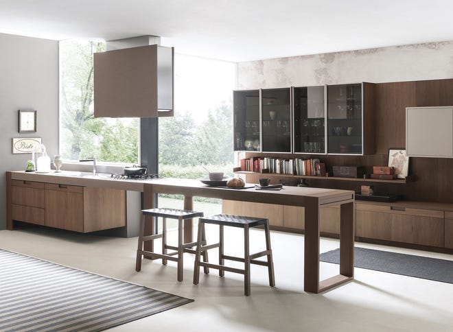 With countertops and an island more akin to fine furniture than traditional American kitchen cabinetry, contemporary Italian style is often unadorned, featuring flush doors, natural materials and rich monochromatic colors.