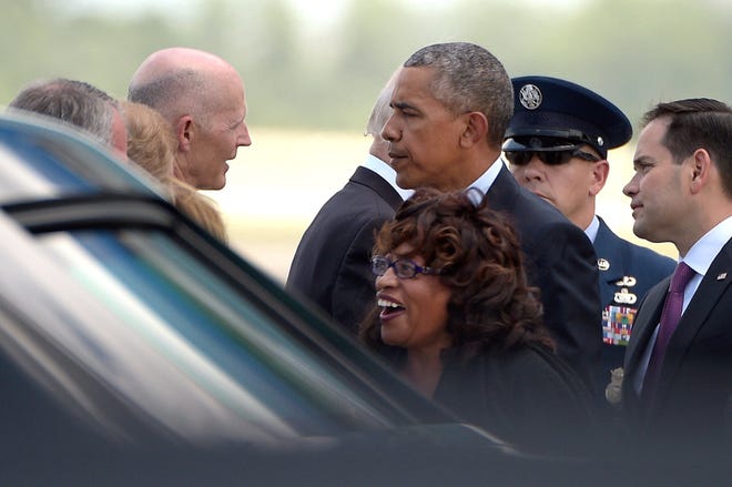 Florida Gov. Rick Scott greets President Barack Obama after after the president arrived on Air Force One with Rep. Corrine Brown, D-Fla., front, and Sen. Marco Rubio, R-Fla., in Orlando, Fla., Thursday, June 16, 2016. (AP Photo/Phelan M. Ebenhack)