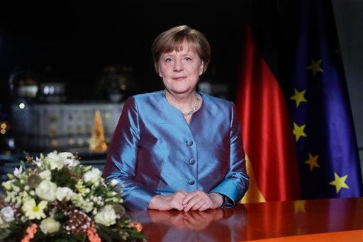 German Chancellor Angela Merkel poses for photographs after the television recording of her annual New Year's speech at the chancellery in Berlin, Friday, Dec. 30, 2016, (AP Photo/Markus Schreiber, Pool)