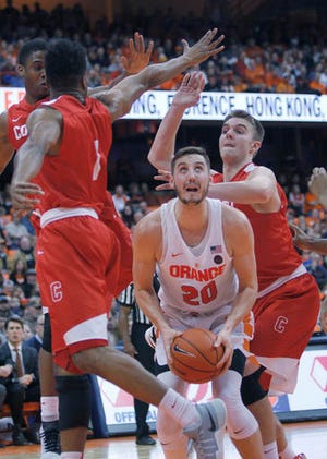 Syracuse's Tyler Lydon, center, tries to shoot as he is surrounded by Cornell players in the second half of an NCAA college basketball game in Syracuse, N.Y., Tuesday, Dec. 27, 2016. Syracuse won 80-56. (AP Photo/Nick Lisi)