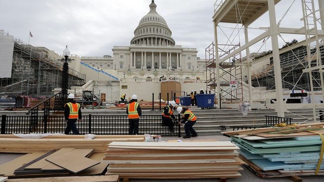 WASHINGTON, DC - DECEMBER 08: Employees of the Architect of the Capitol put up a fence at the West Front of the Capitol as construction of the 2017 presidential inaugural platform continues December 8, 2016 on Capitol Hill in Washington, DC. The inaugural platform will be used for swearing in the nation's 45th president Donald Trump on January 20, 2017. (Photo by Alex Wong/Getty Images)