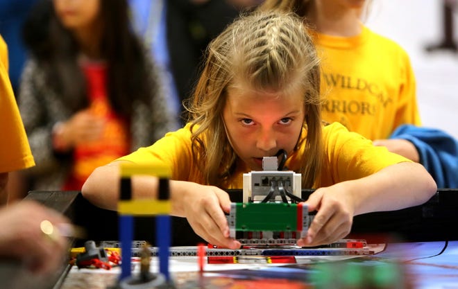 Brittany Randolph/The StarJessie Ozmore of West Elementary School lines a robot up for a round at the Cleveland County Schools robotics tournament in April.